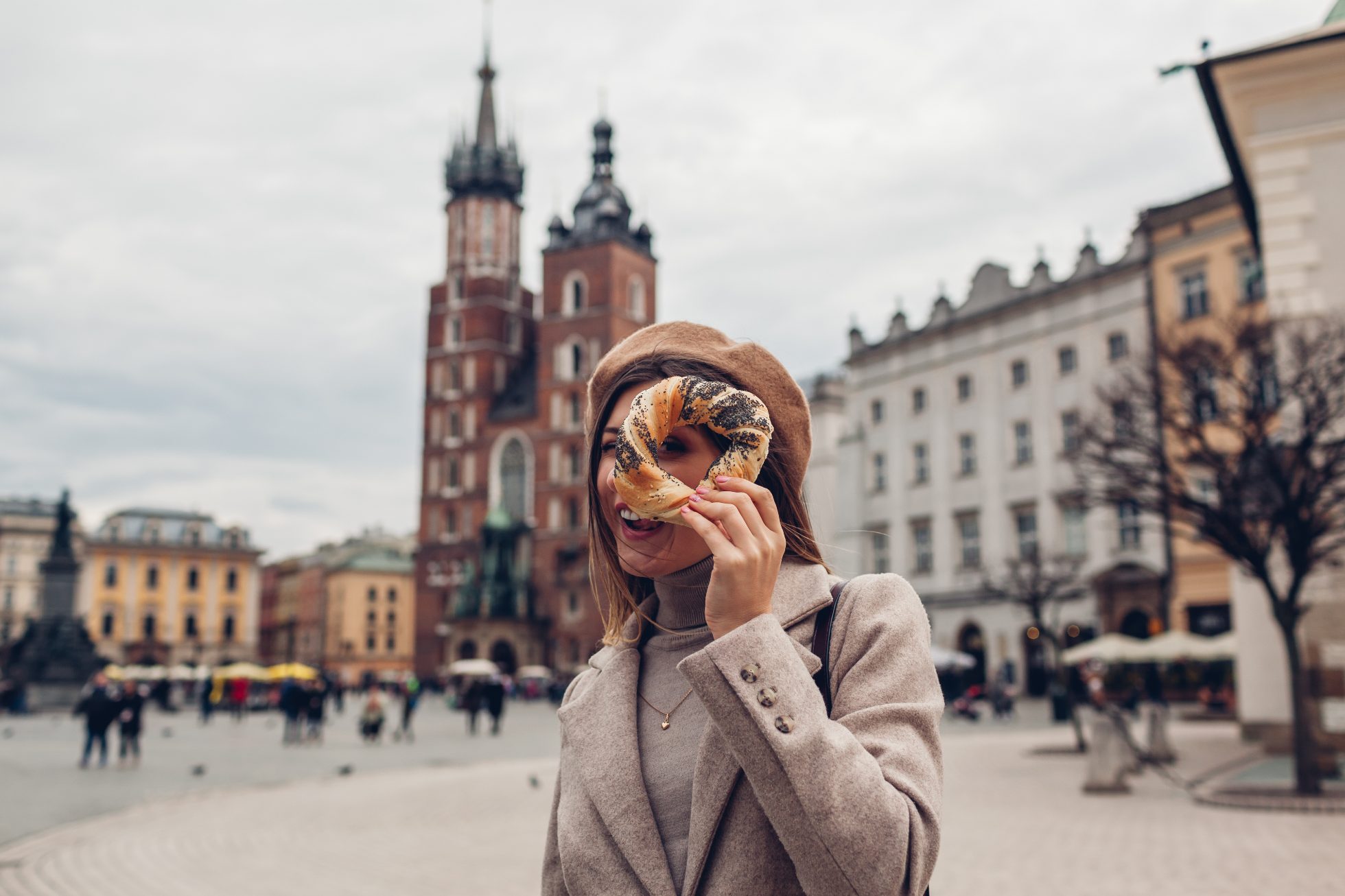 A cheerful girl with an bagel in Krakow