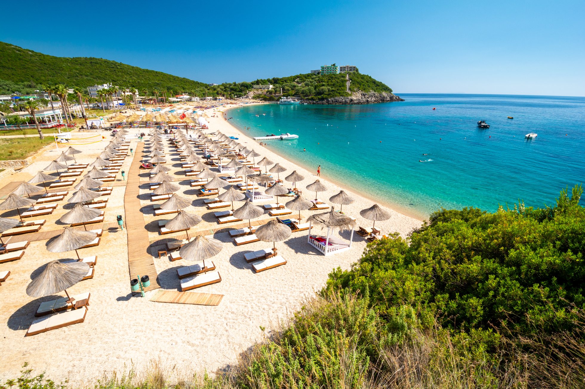 Plaża w Dhermi, Albania. Błękitne morze, złoty piasek i skaliste wybrzeże.
