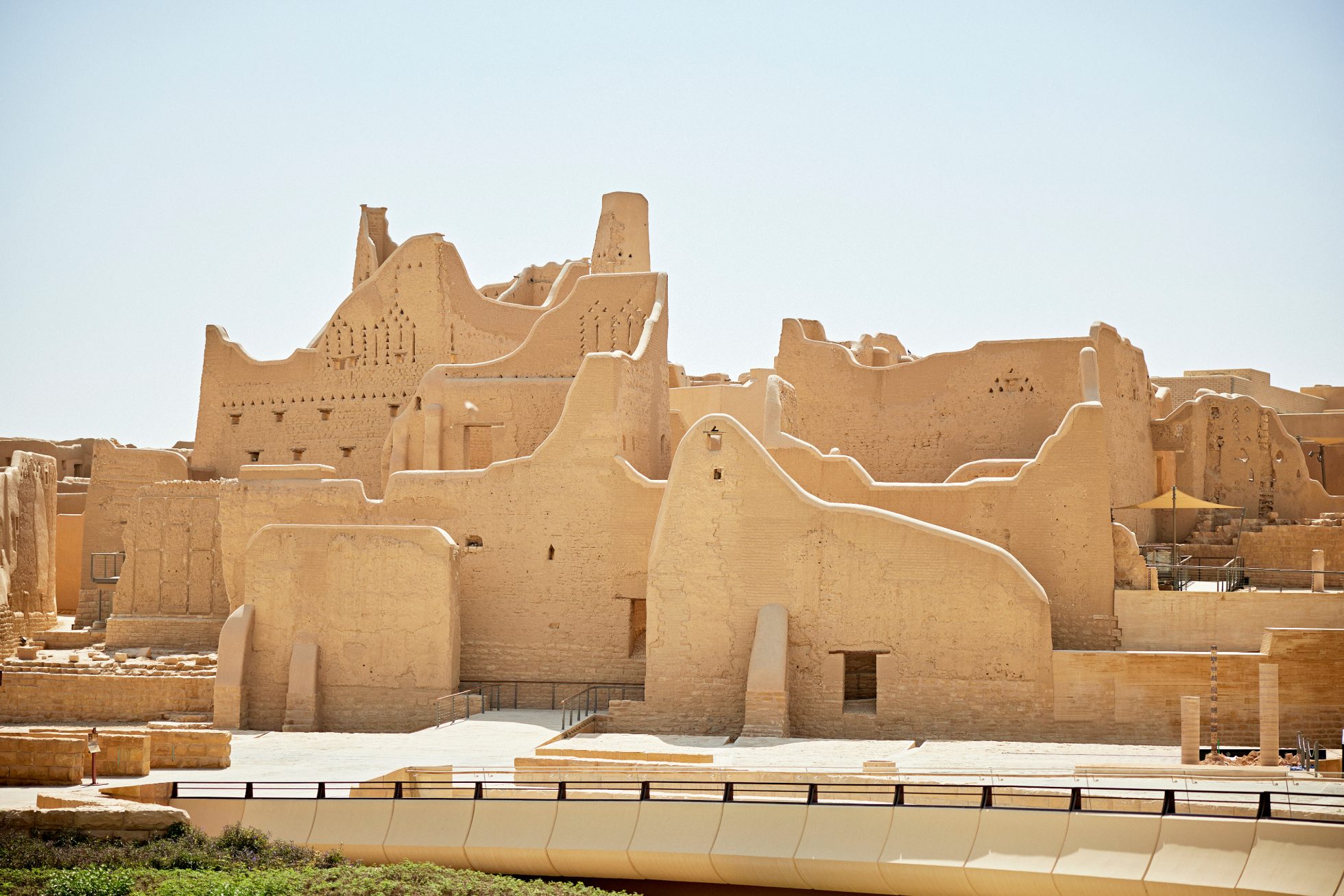 Saudi Arabian desert landscape with rocky formations and dry vegetation.
