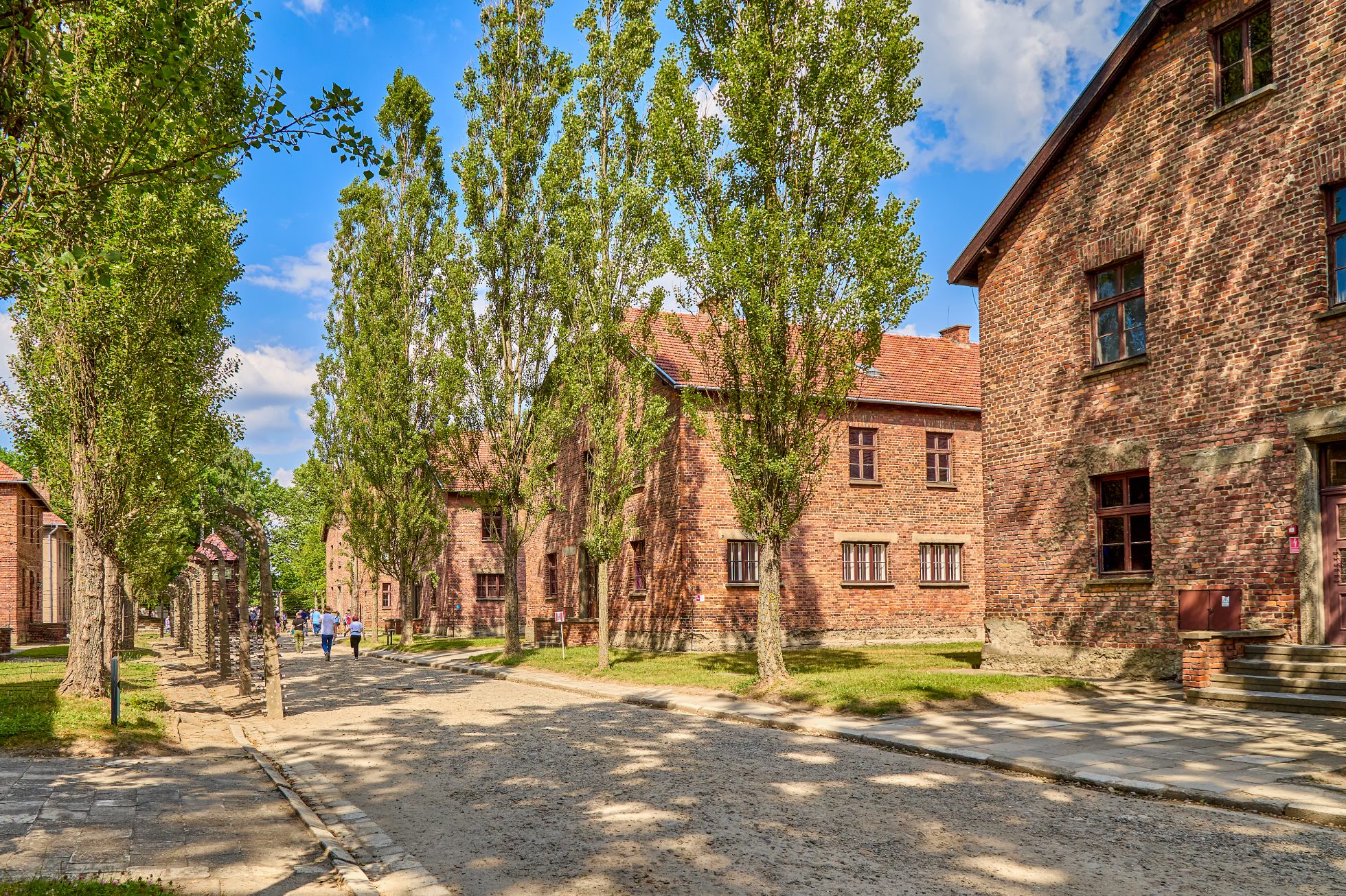 Buildings and prisoner barracks with barbed wire fences at Auschwitz concentration camp.