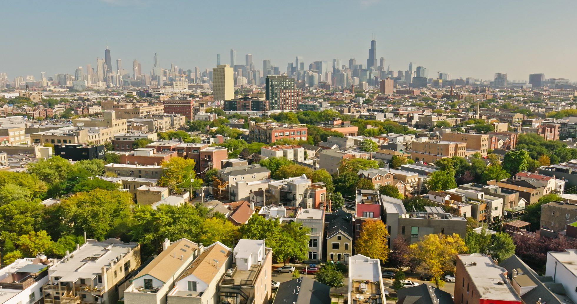 Aerial shot of Wicker Park, Chicago, Illinois with the downtown skyline in the background on a clear day in Fall.