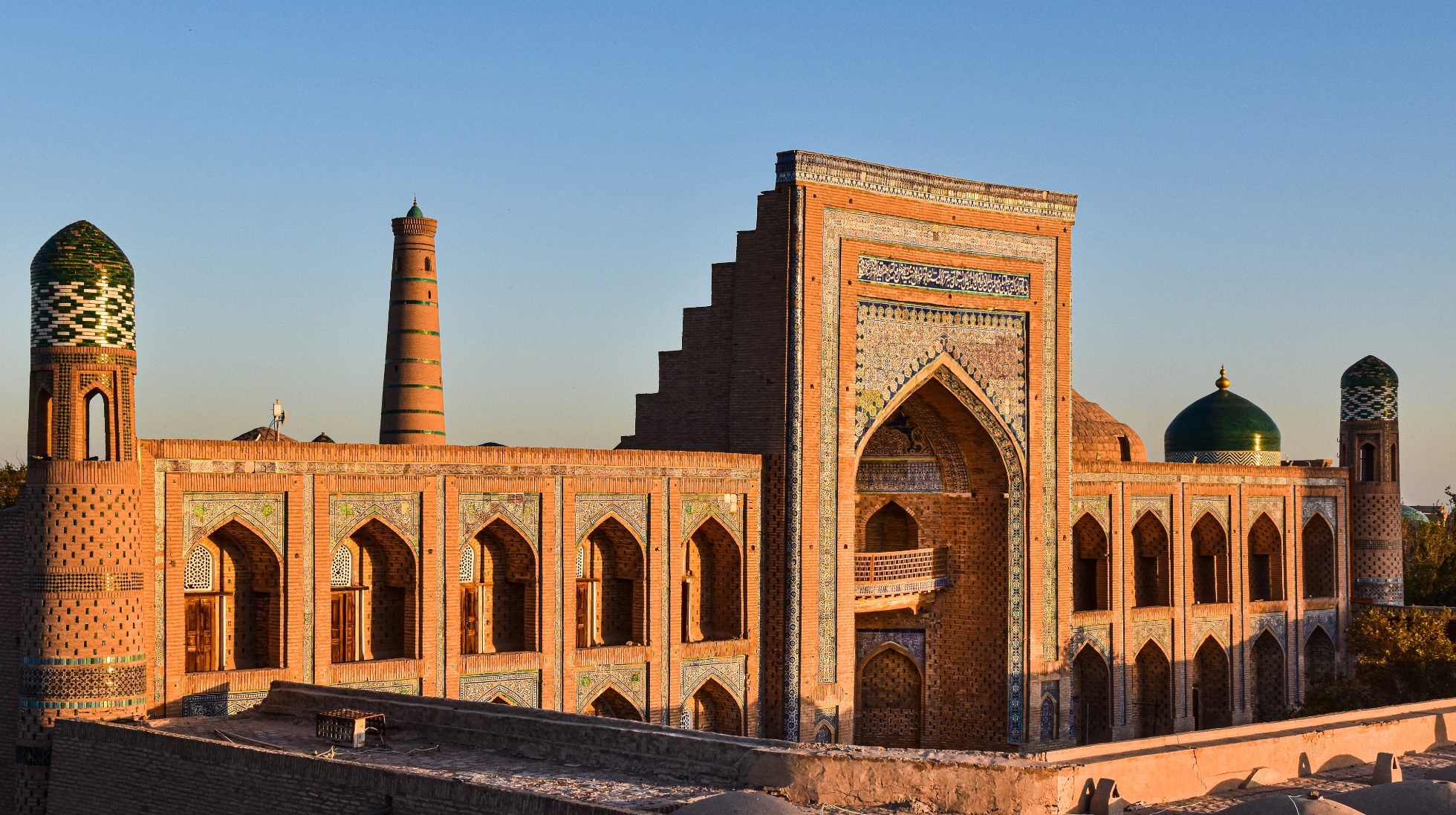View of a building in Khiva, Uzbekistan, with the setting sun in the background, Uzbekistan attractions