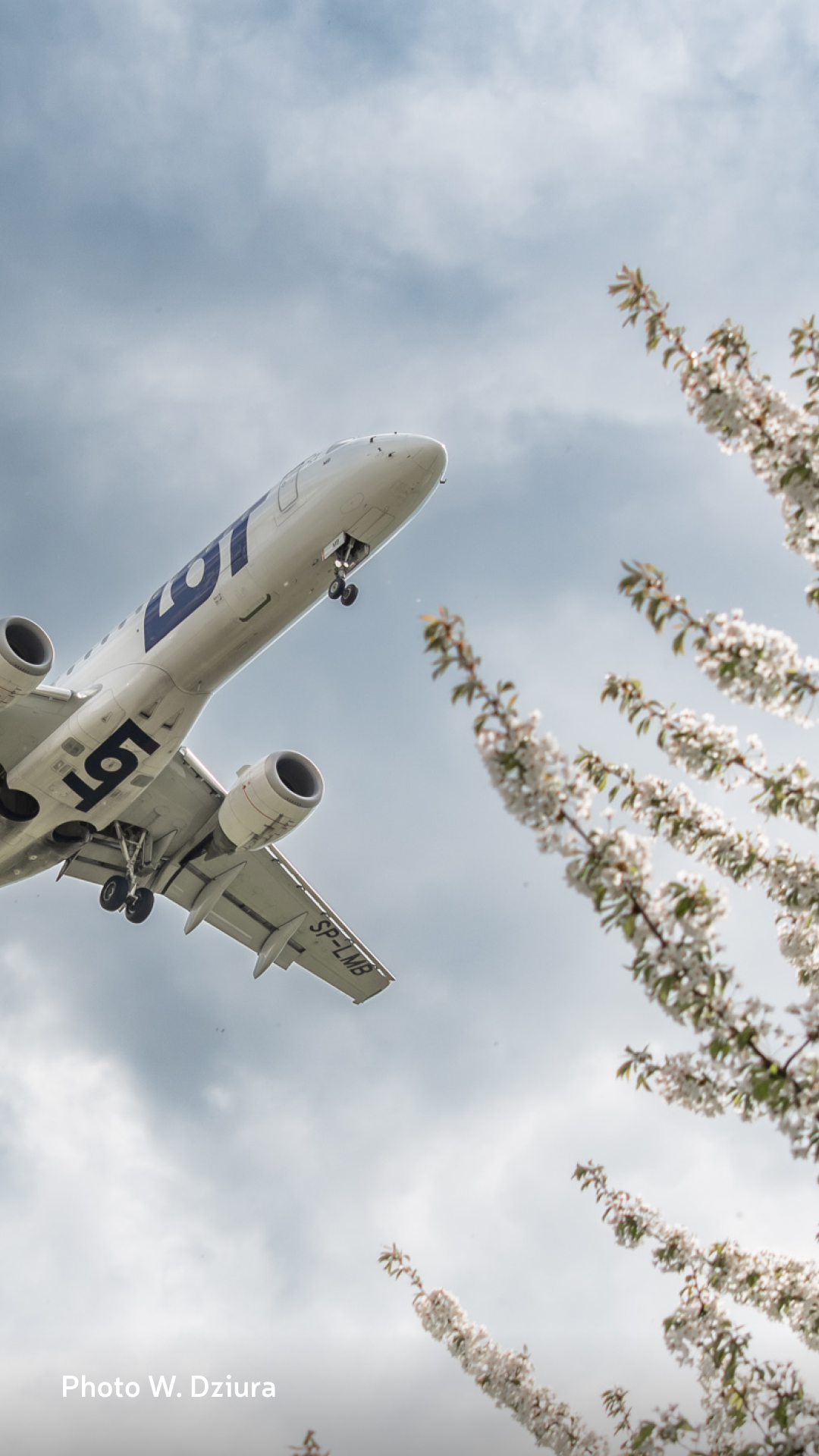Embraer 190 approaching airport on a cloudy day