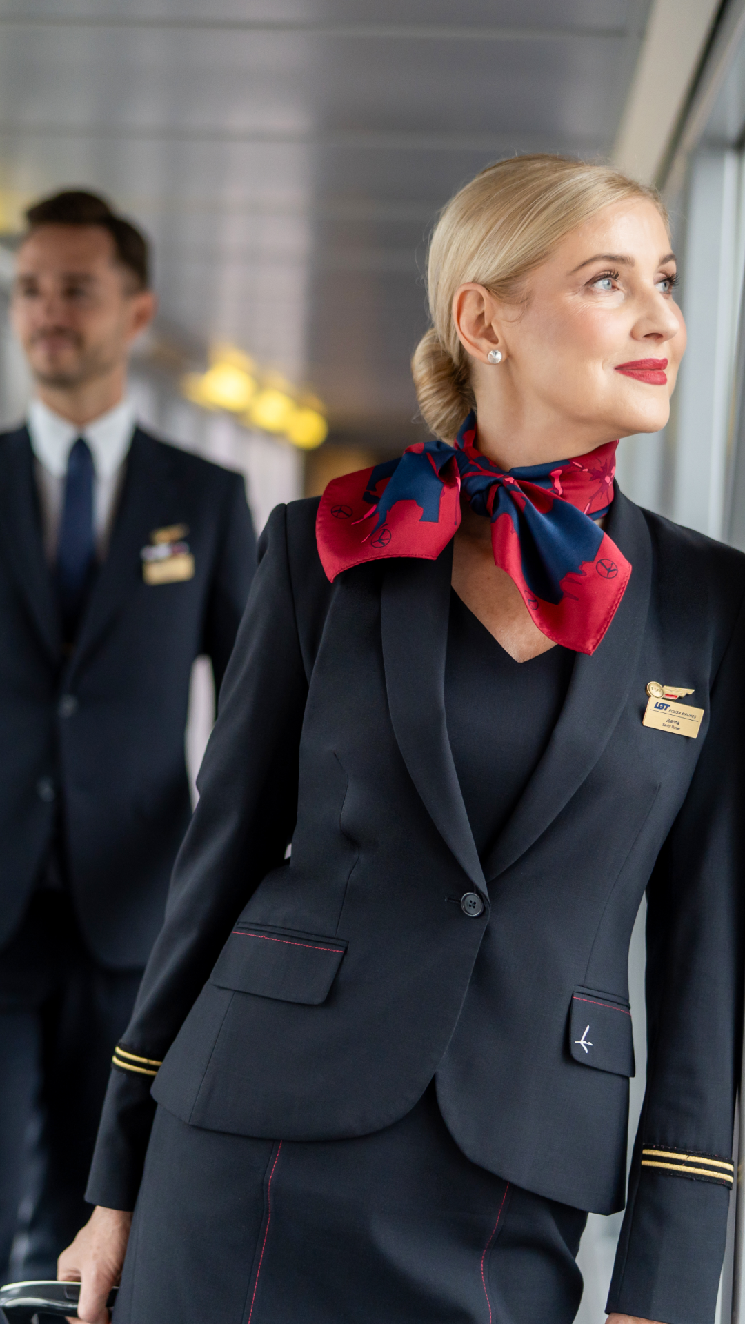 The flight crew walking through the tunnel to the airport wearing hollyhock scarves