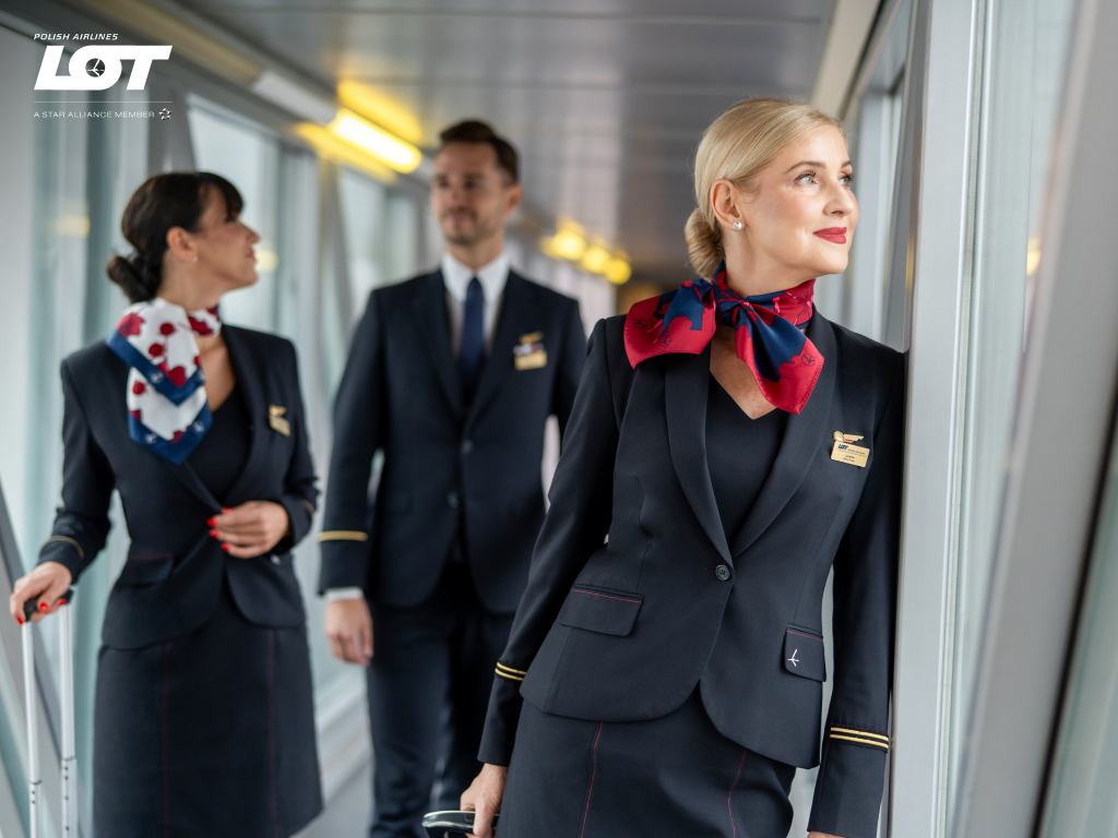 The flight crew walking through the tunnel to the airport wearing hollyhock scarves