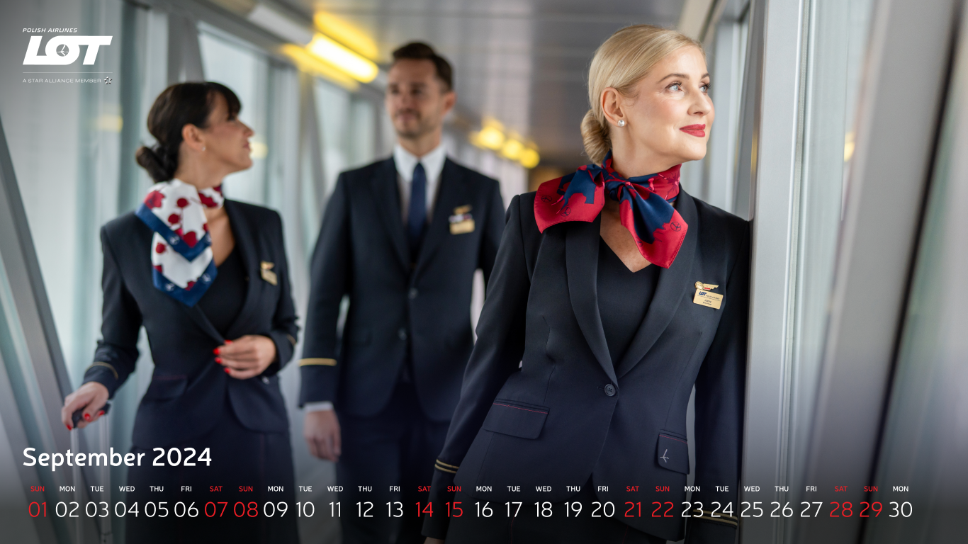 The flight crew walking through the tunnel to the airport wearing hollyhock scarves