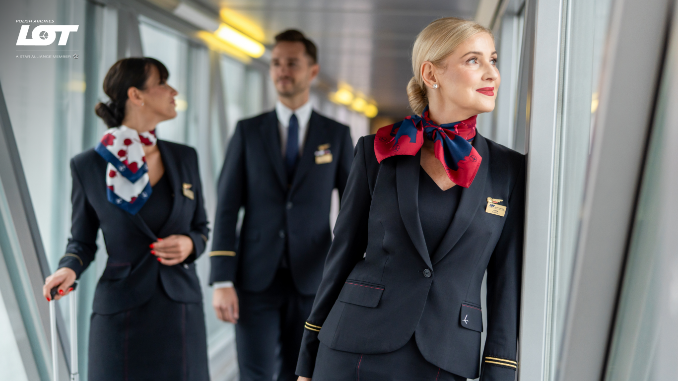 The flight crew walking through the tunnel to the airport wearing hollyhock scarves