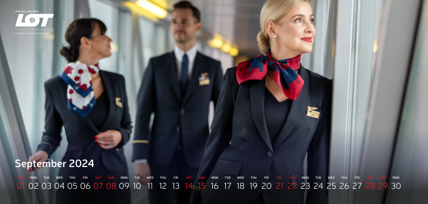 The flight crew walking through the tunnel to the airport wearing hollyhock scarves
