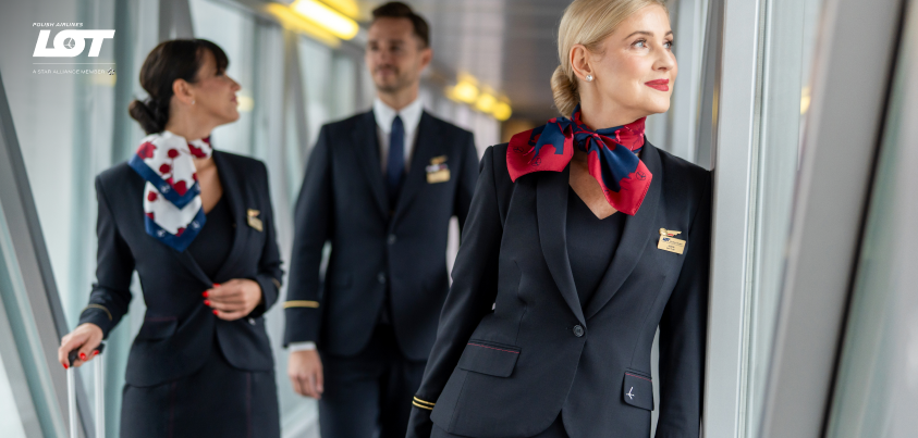 The flight crew walking through the tunnel to the airport wearing hollyhock scarves