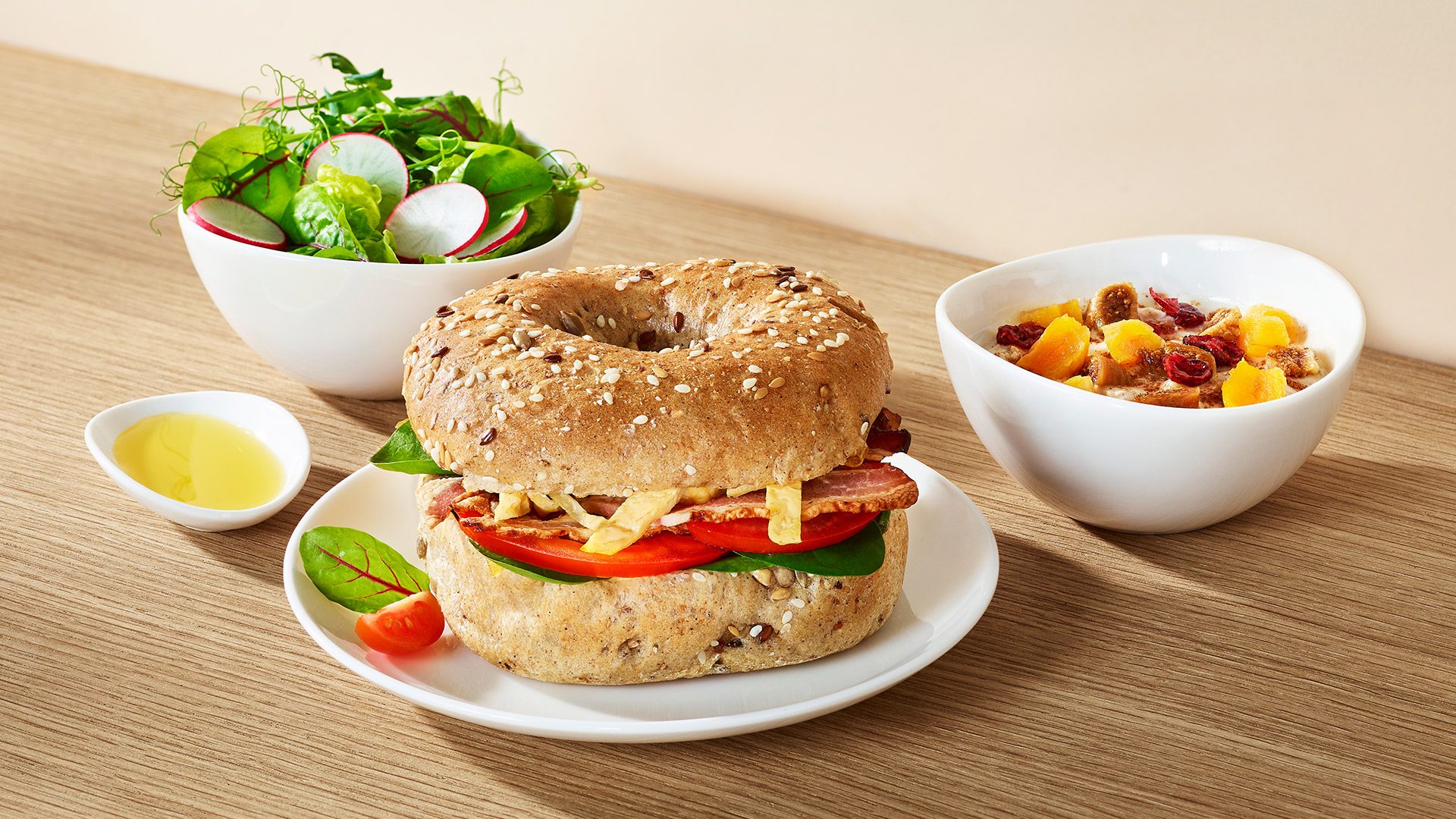 Multigrain bagel with omelet, bacon, tomatoes, and spinach. Romaine lettuce with sorrel and pea sprouts. For dessert – cinnamon porridge with dried apricots and figs. Served with extra virgin olive oil. 