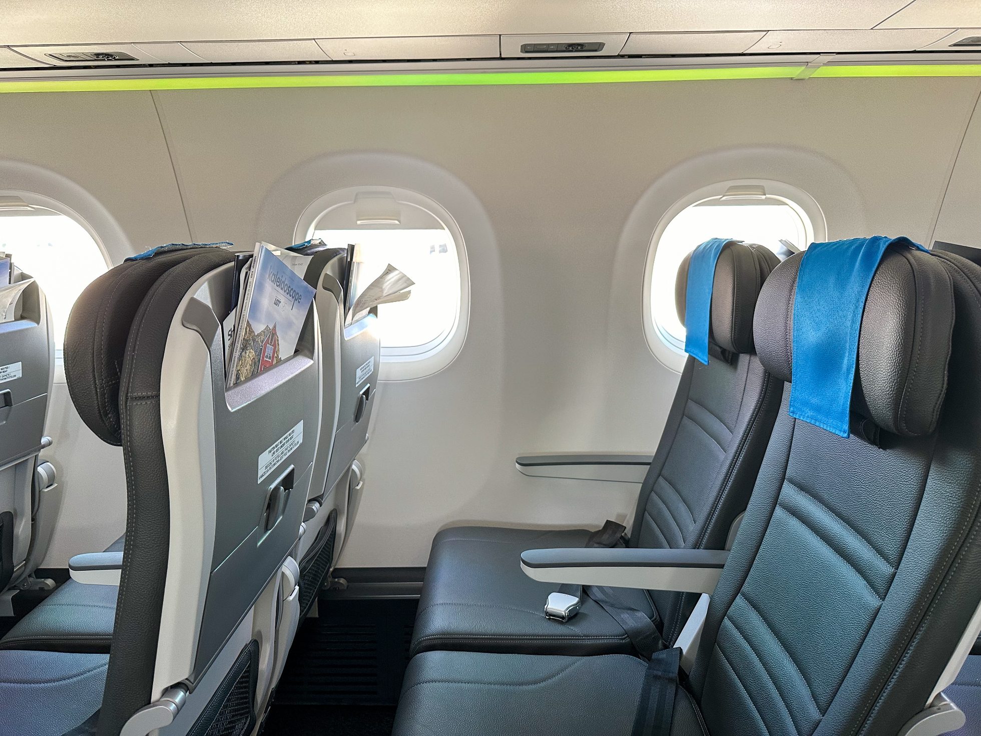 LOT Airlines economy class passenger plane. Comfortable seats, carry-on baggage space, and individual lighting.