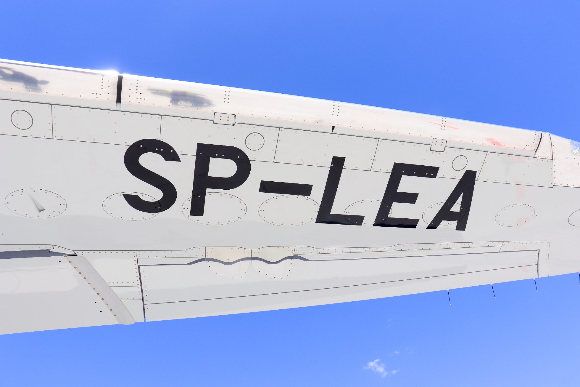 Embraer E2 aircraft wing against the sky.