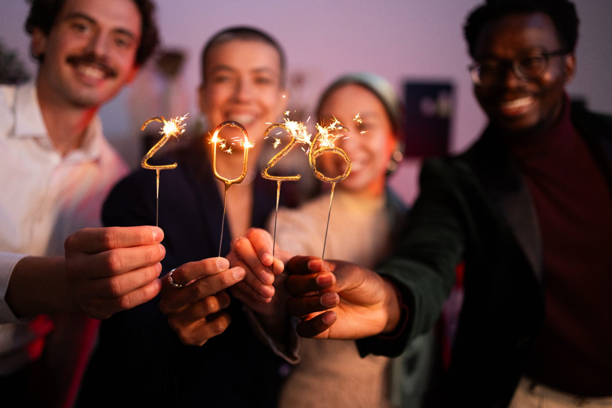 Group of friends holding the number 2024, celebration conceptual image for New Yearâs Eve.