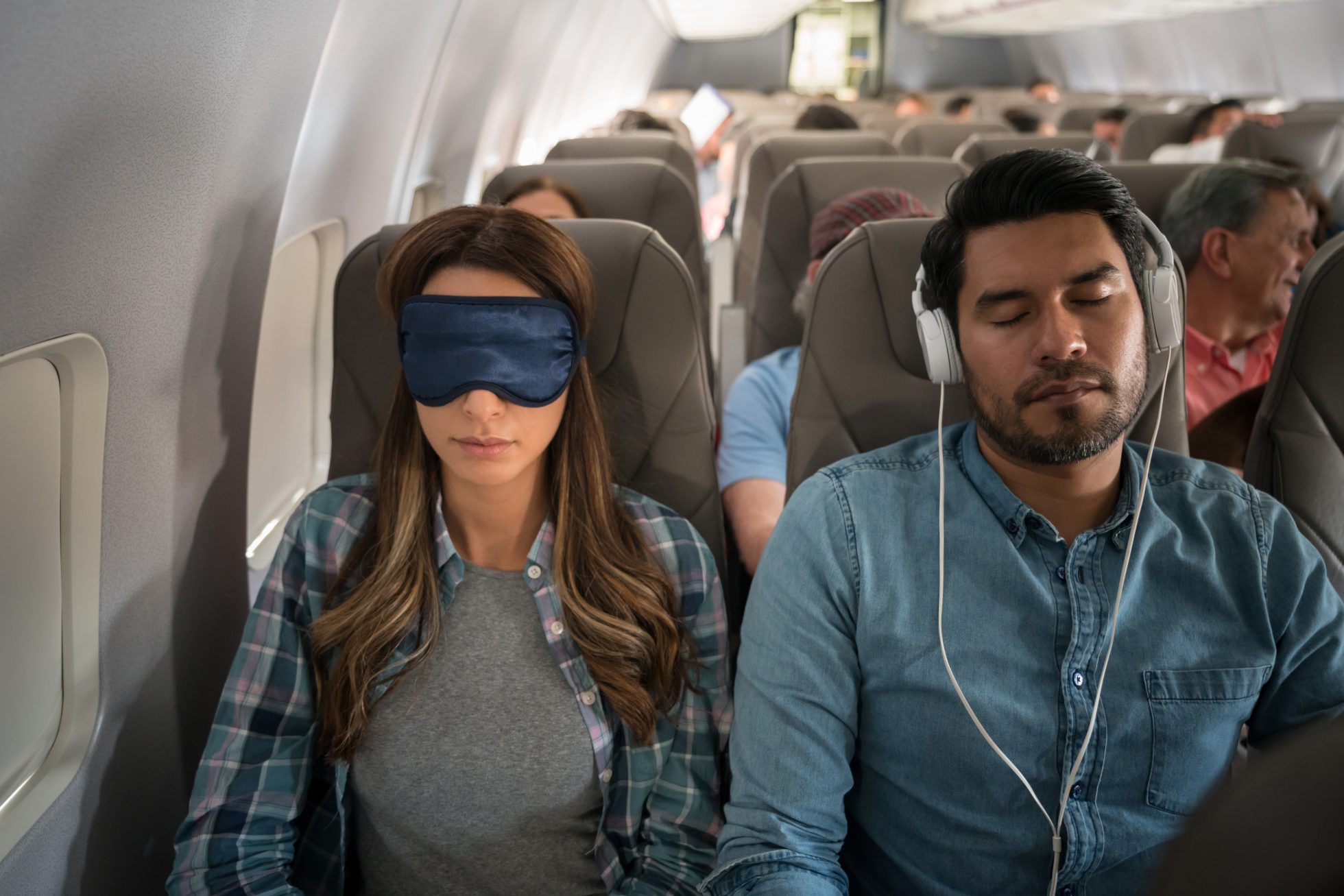 People sleeping on a plane.