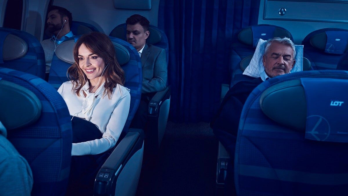 Woman in business class watching movie