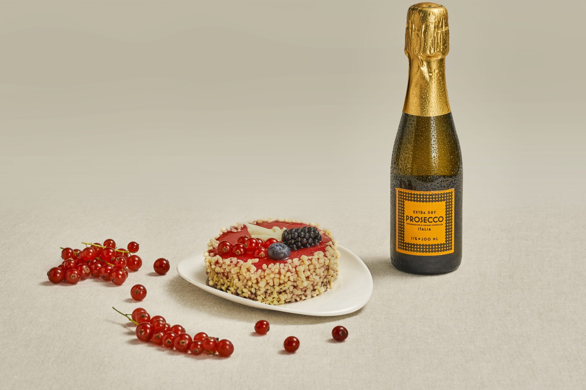 Torta al ribes con una bottliglia di Prosecco frizzante