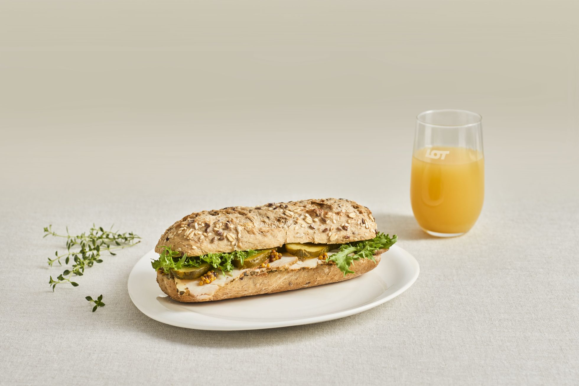 The image shows a meal set with juice and a sandwich.
