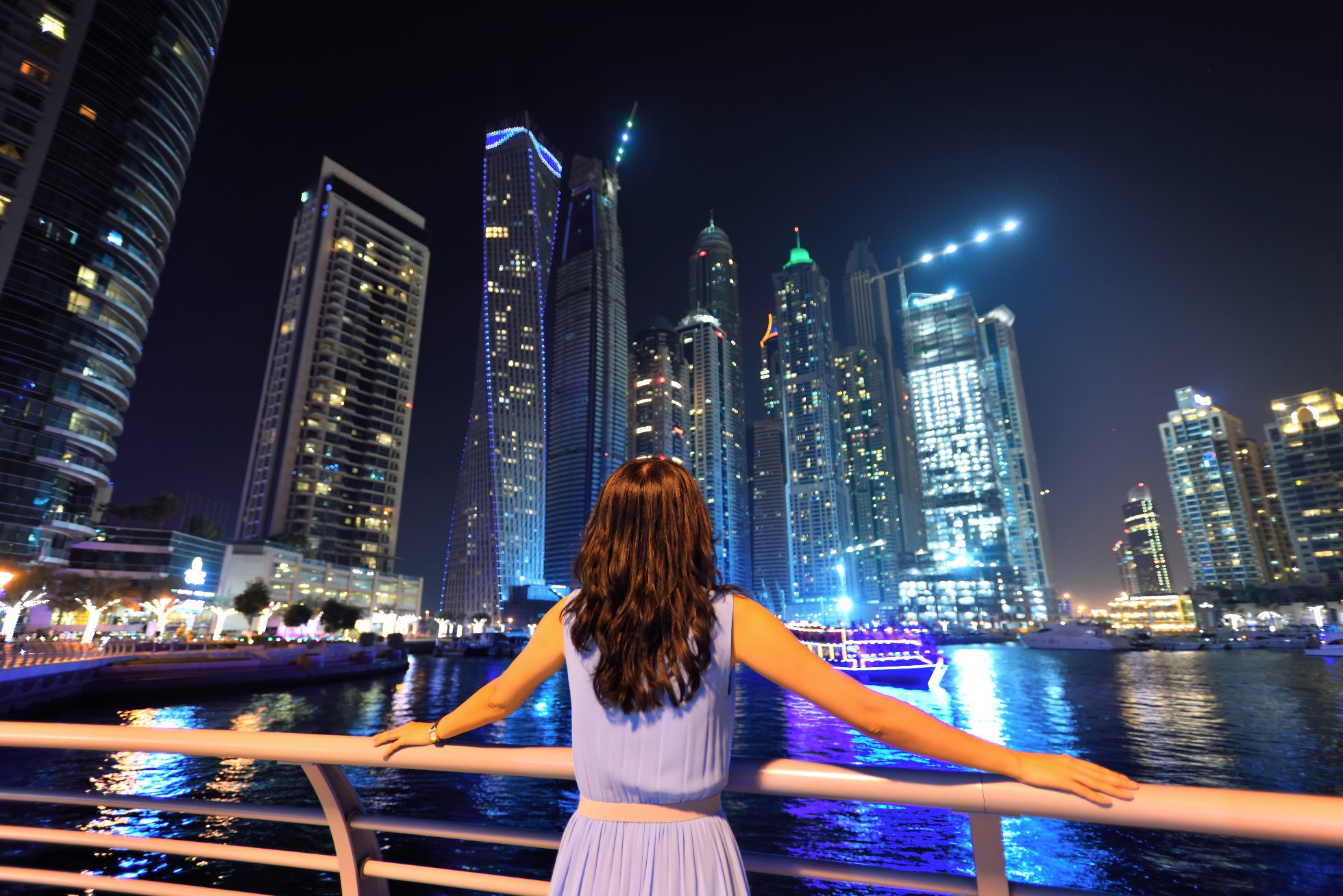 Asian woman looking at Dubai skyline, Dubai vacation