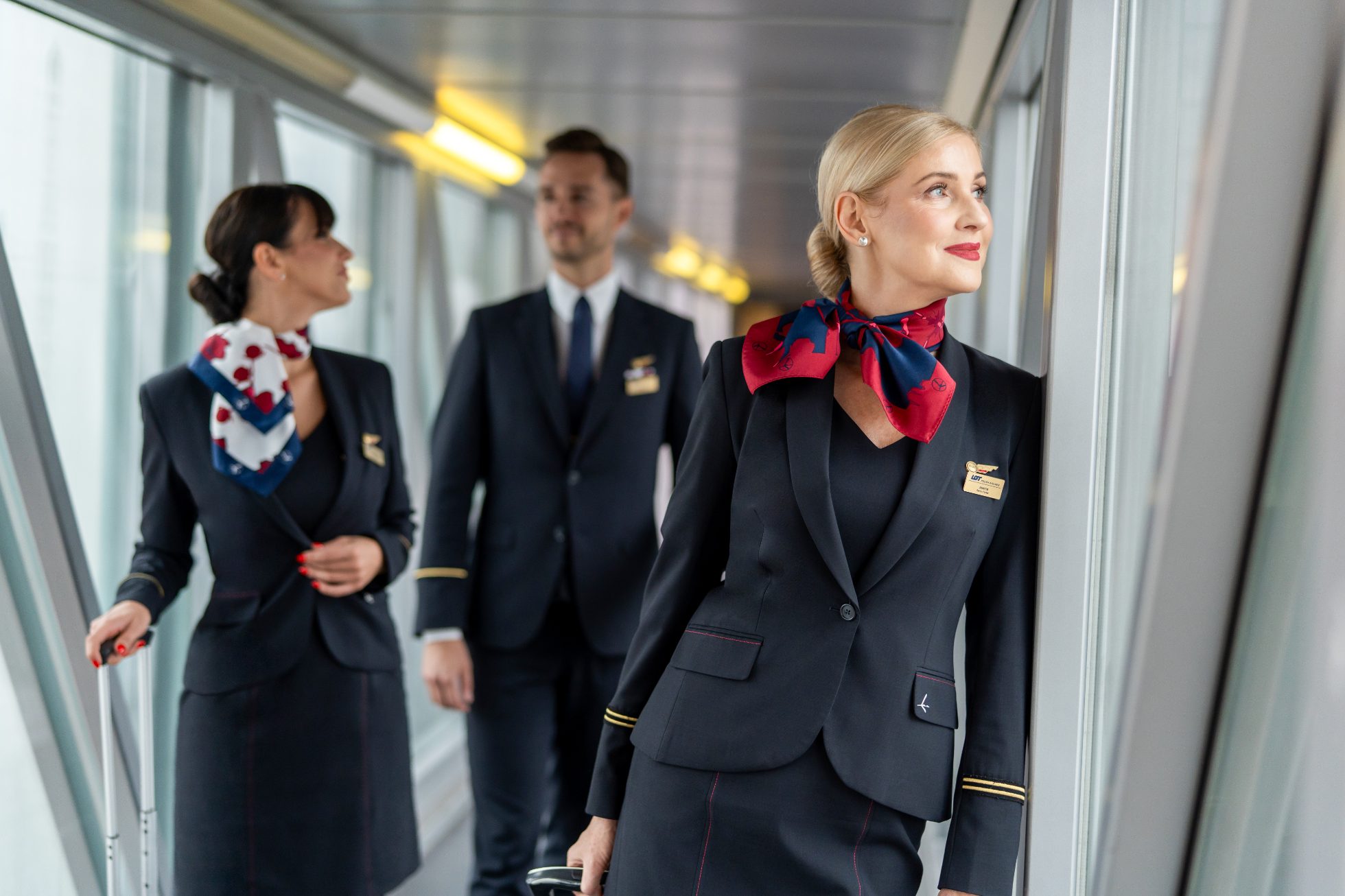 LOT Polish Airlines cabin crew members in jet bridge before boarding plane
